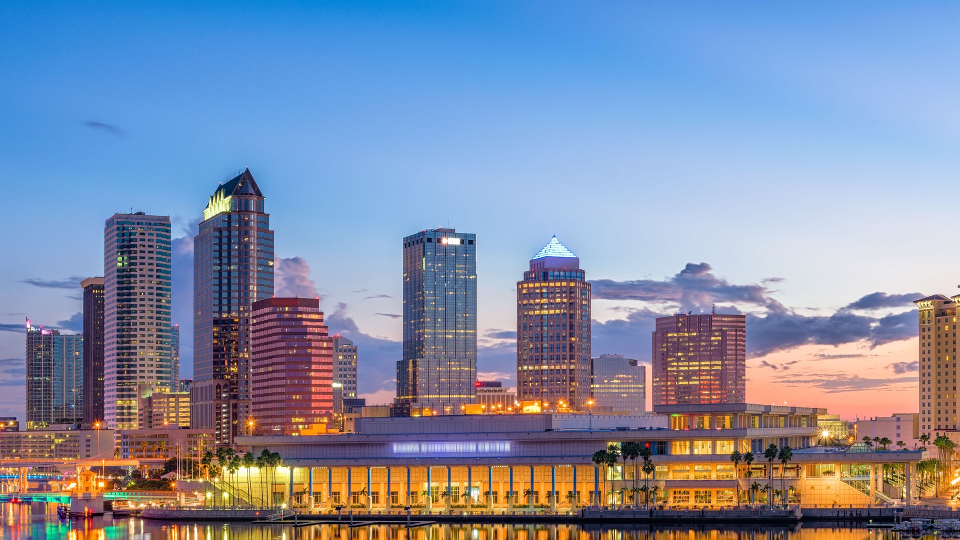 Tampa, Florida downtown skyline at sunset with high-rise buildings along the waterfront, representing the city served by local adult day care centers.