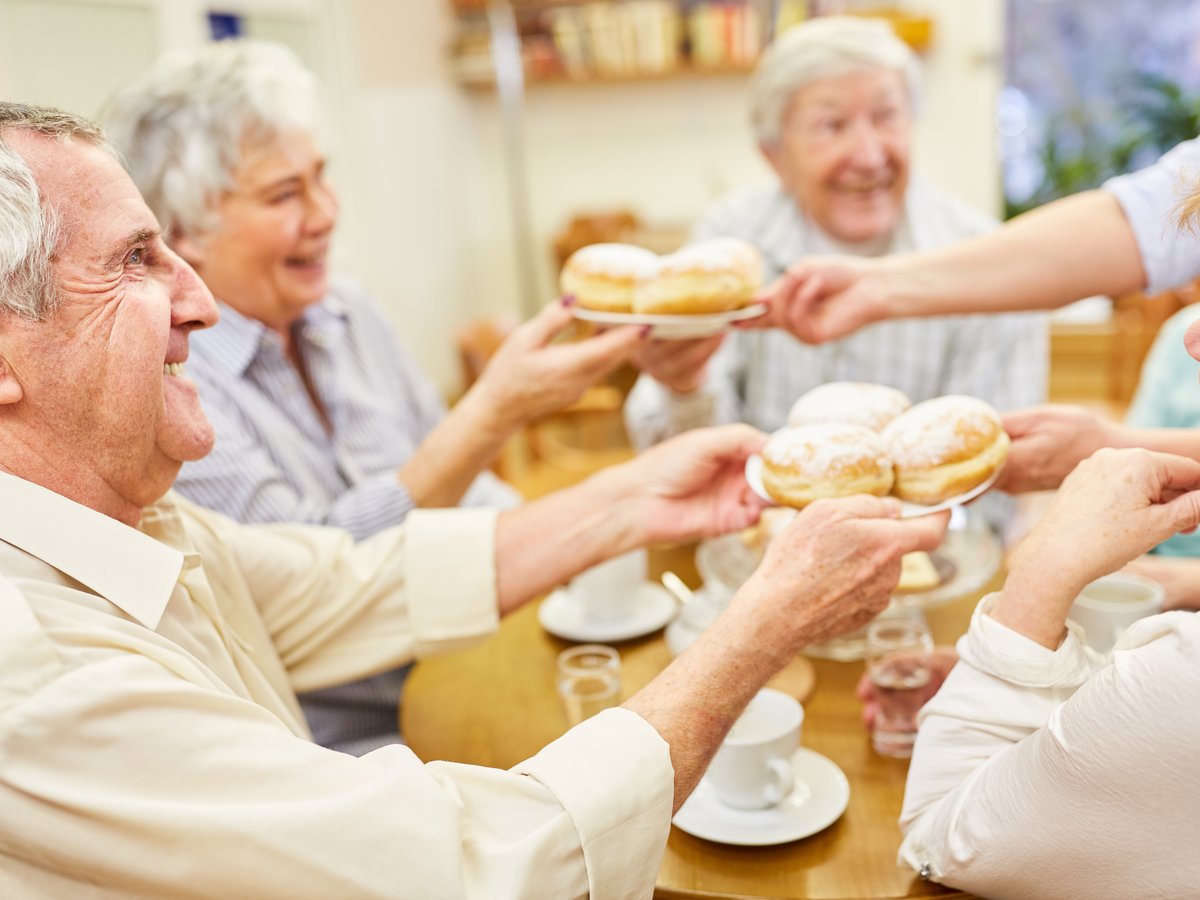 Seniors socializing and sharing a meal at an adult day care in Clermont, Florida