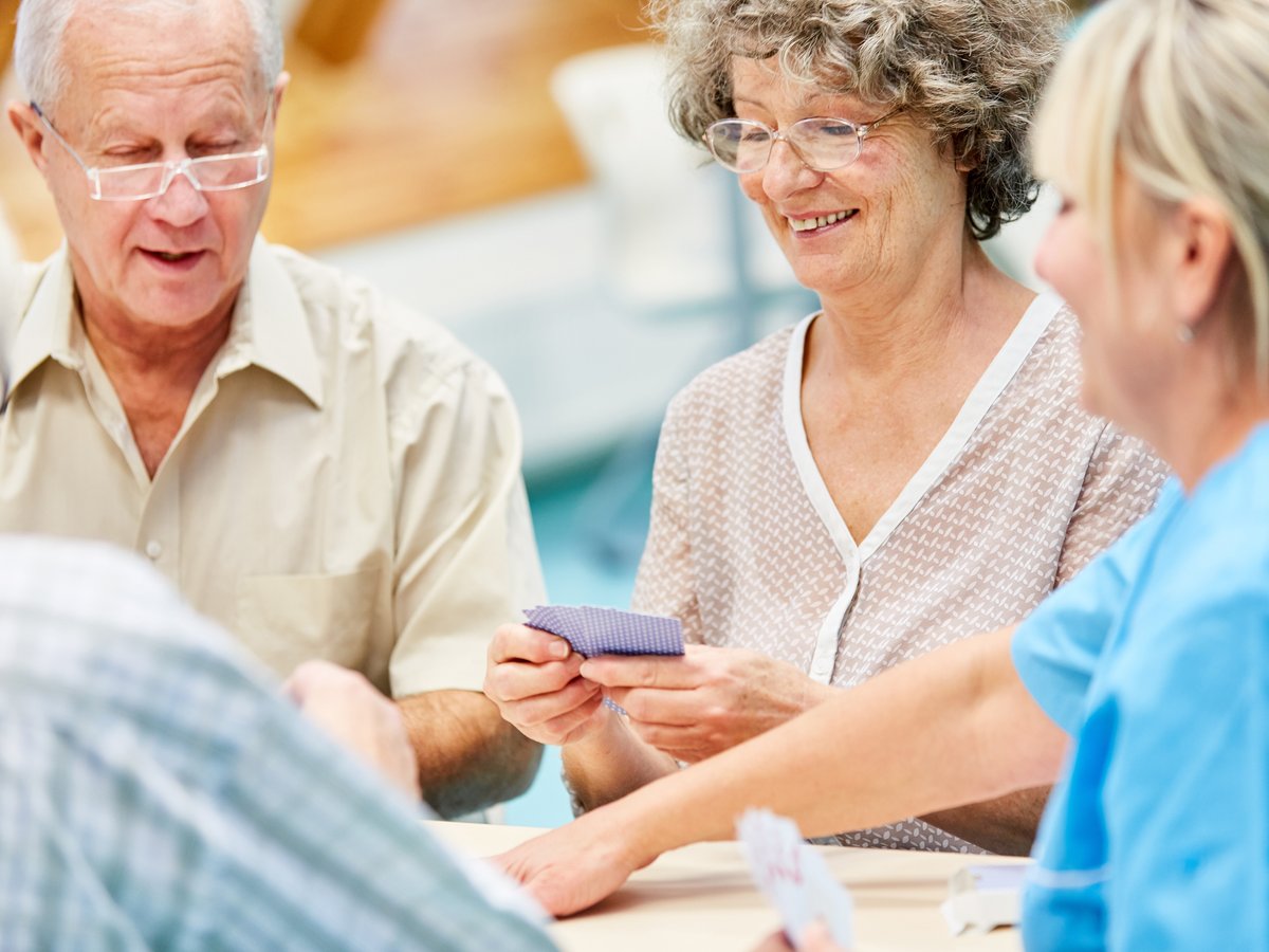 Happy group of seniors socializing at an adult day care.